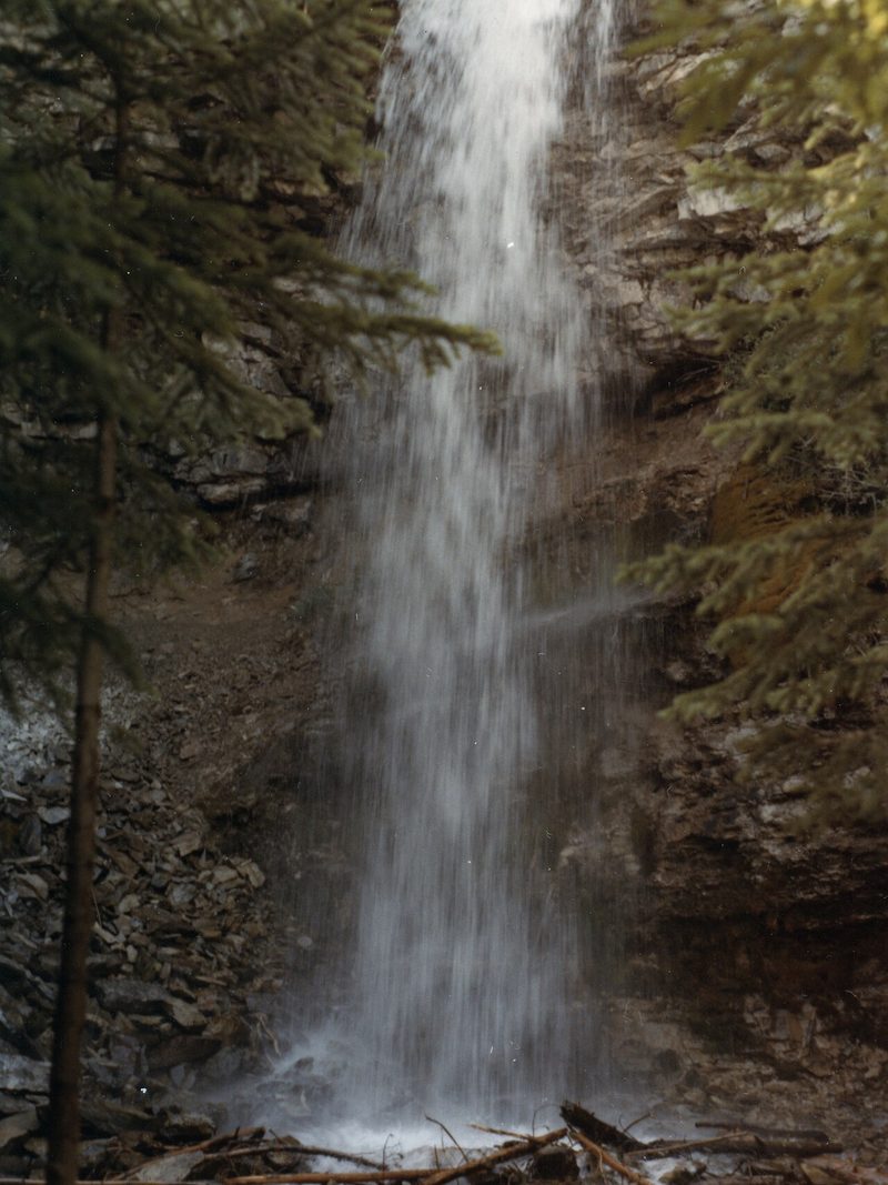 Troll Falls pouring over a rock cliff in Kananaskis Country